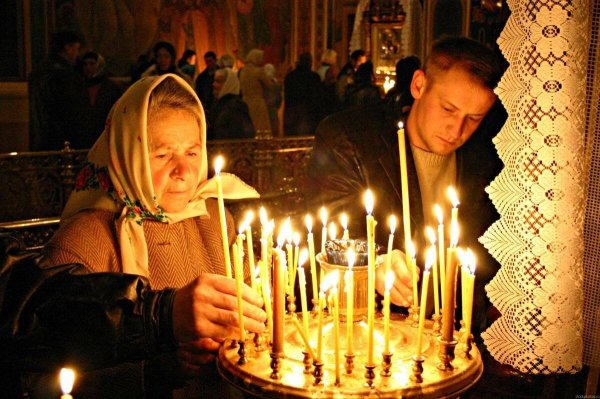 Мужчина со свечами в храме